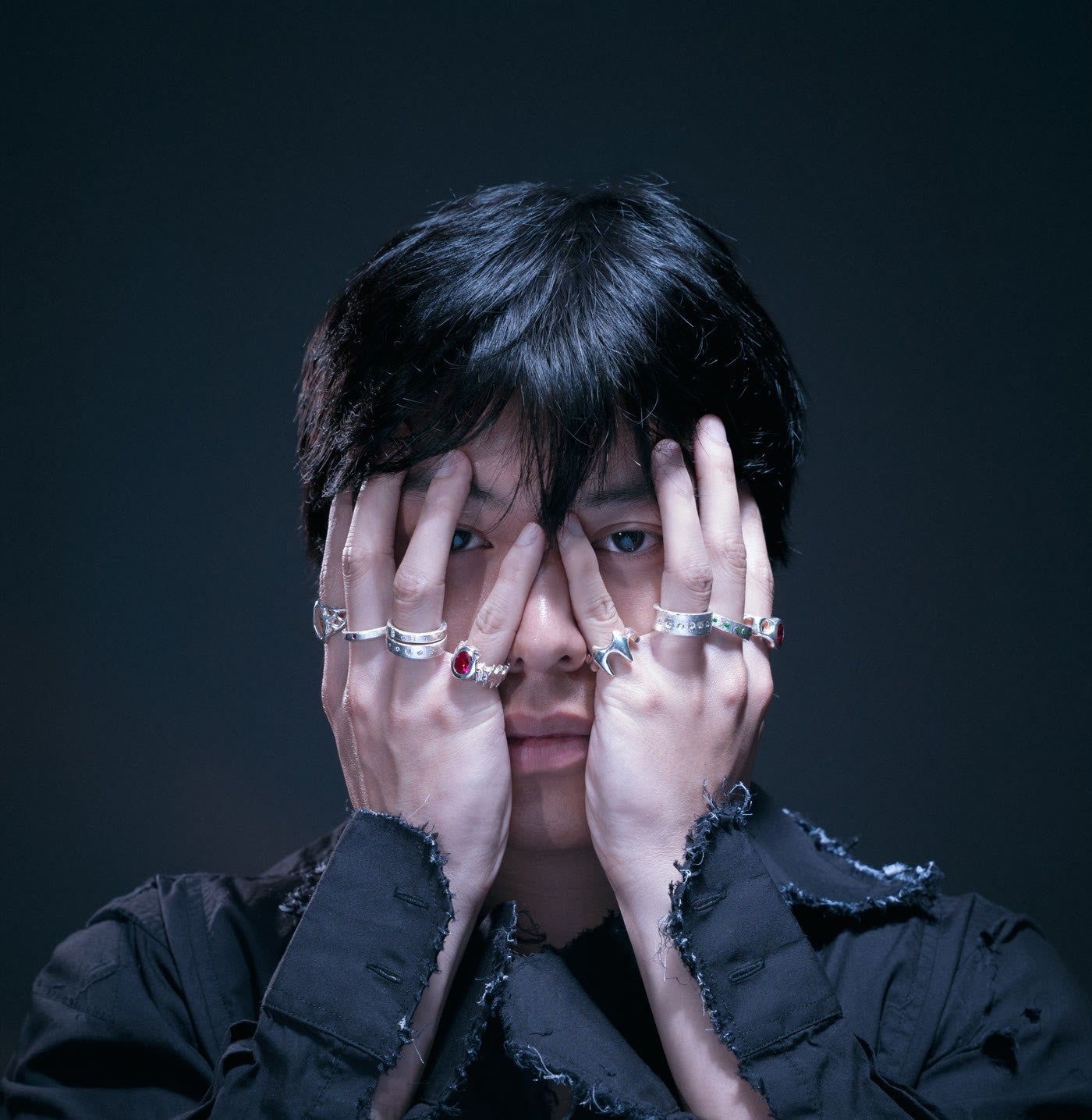 Hands wearing several sterling rings